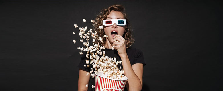girl with 3d glasses and popcorn flying in the air