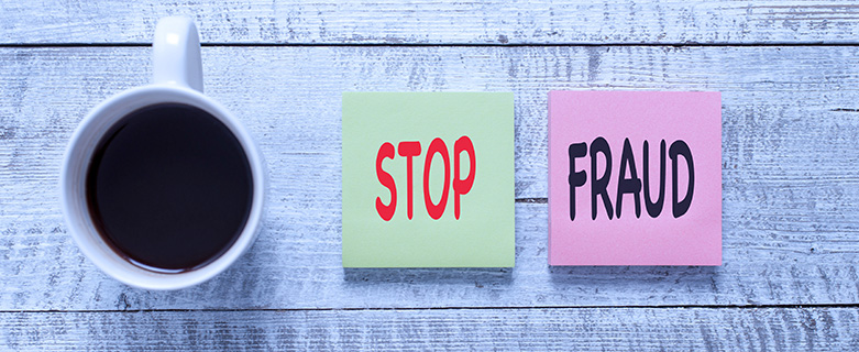 coffee cup next to sticky notes that read stop fraud